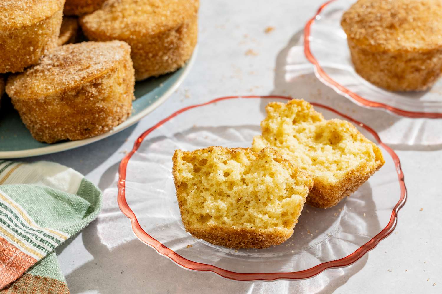 Old-Fashioned Donut Muffins on a platter, one broken in half on a small plate