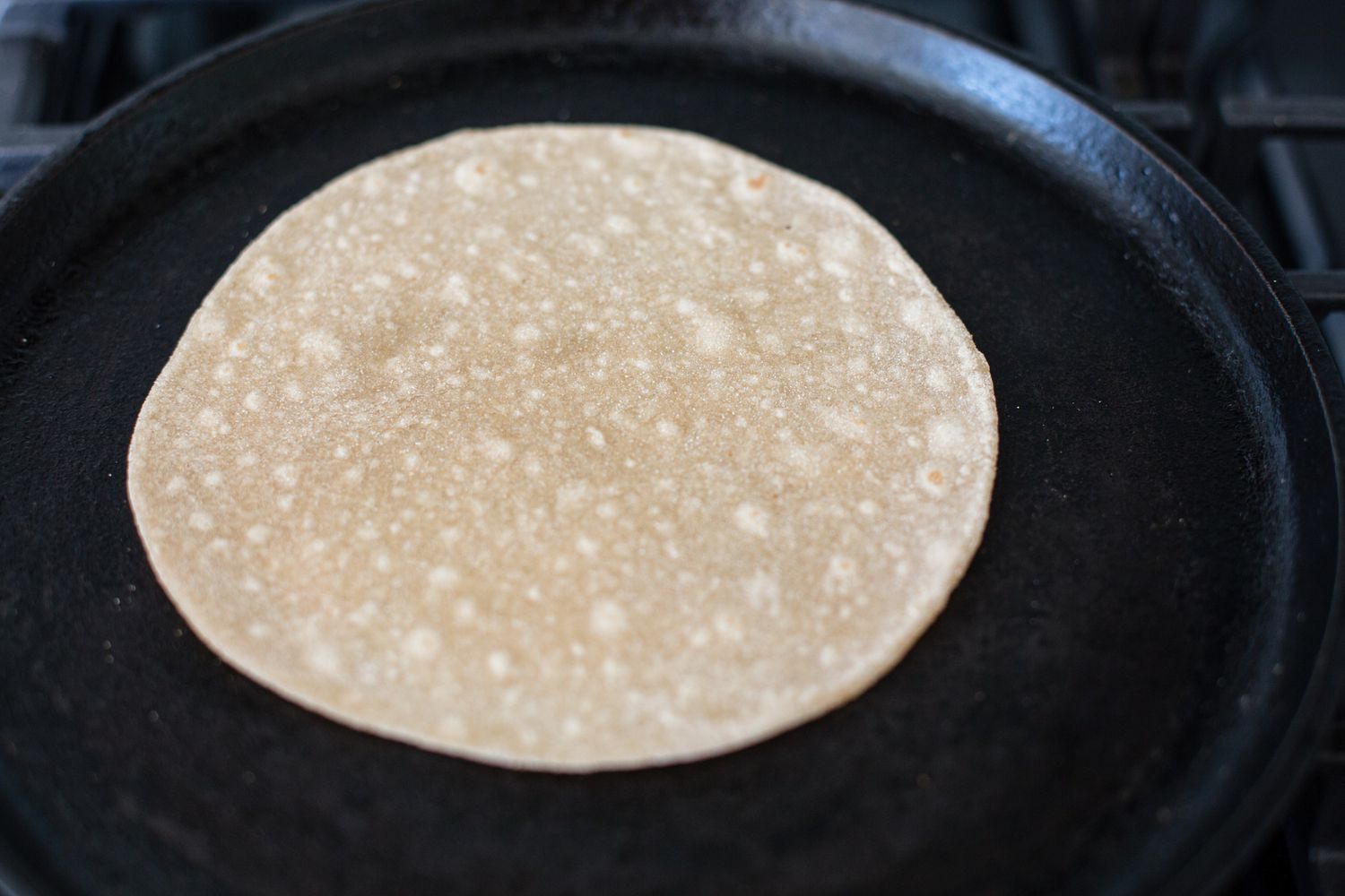 Showing how to make roti on the stovetop.