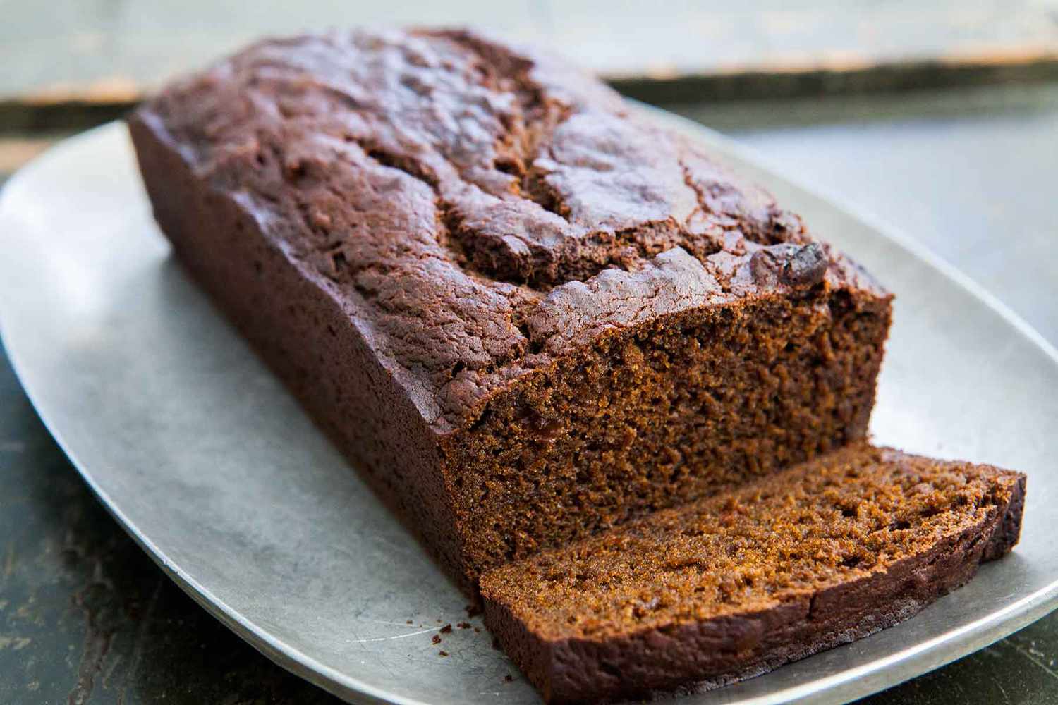 A loaf of pumpkin gingerbread with a slice cut