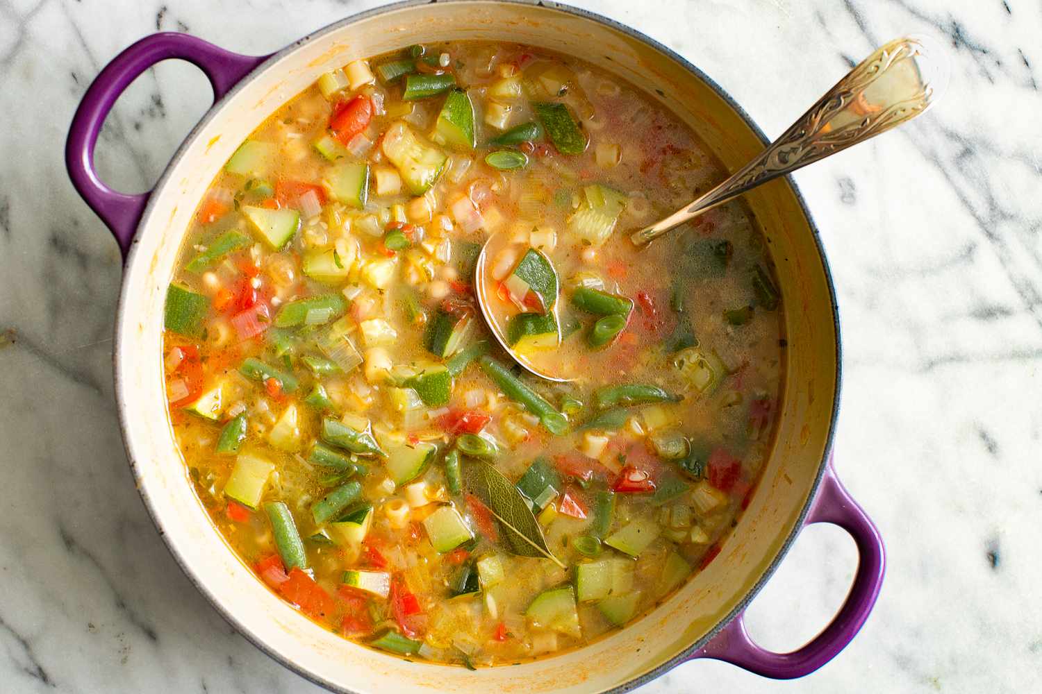 Summer Minestrone Soup in a Dutch Oven With a Ladle