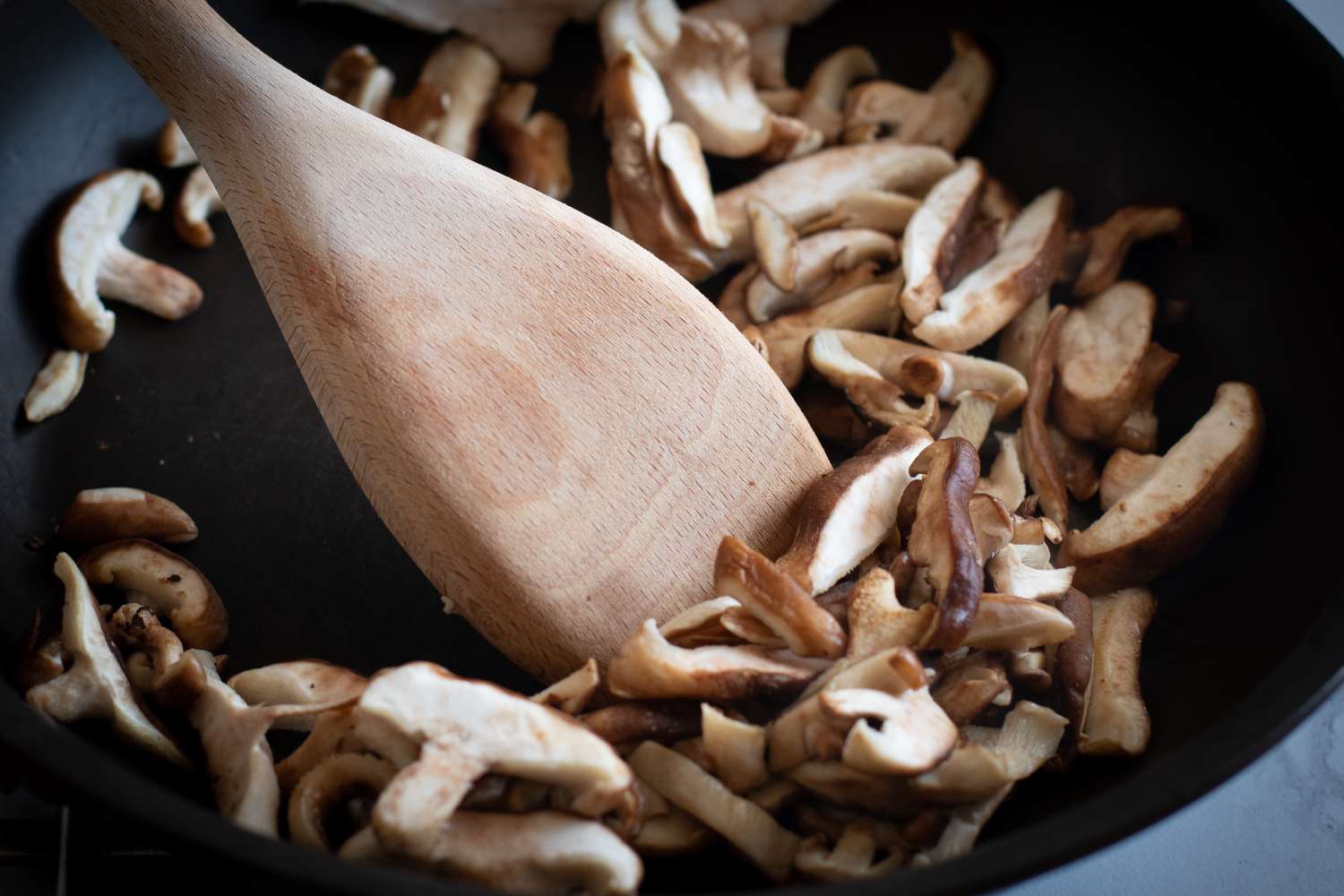 Sauteeing mushrooms for a ground beef and mushroom recipe.