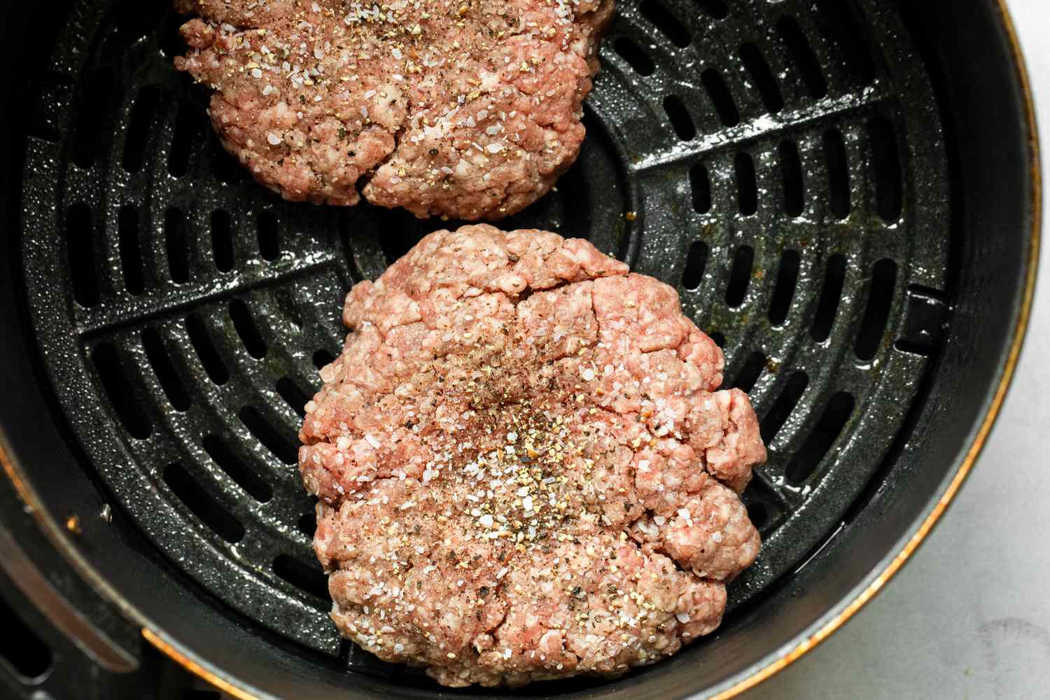 Burger Patties in Air Fryer Seasoned with Salt and Pepper 