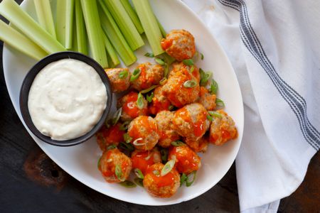 Buffalo chicken meatballs with celery and blue cheese.