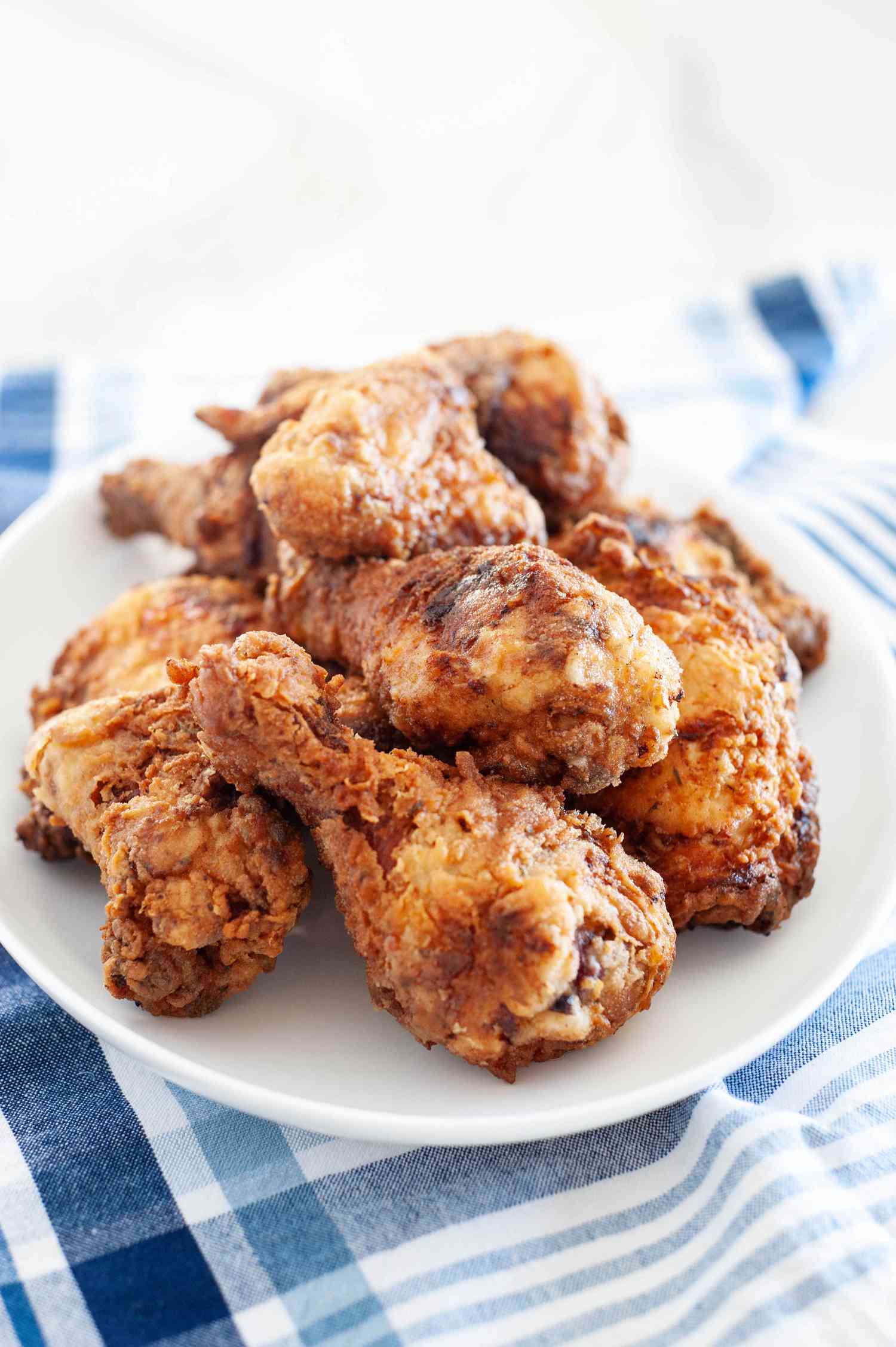 A plate stacked with buttermilk fried chicken.