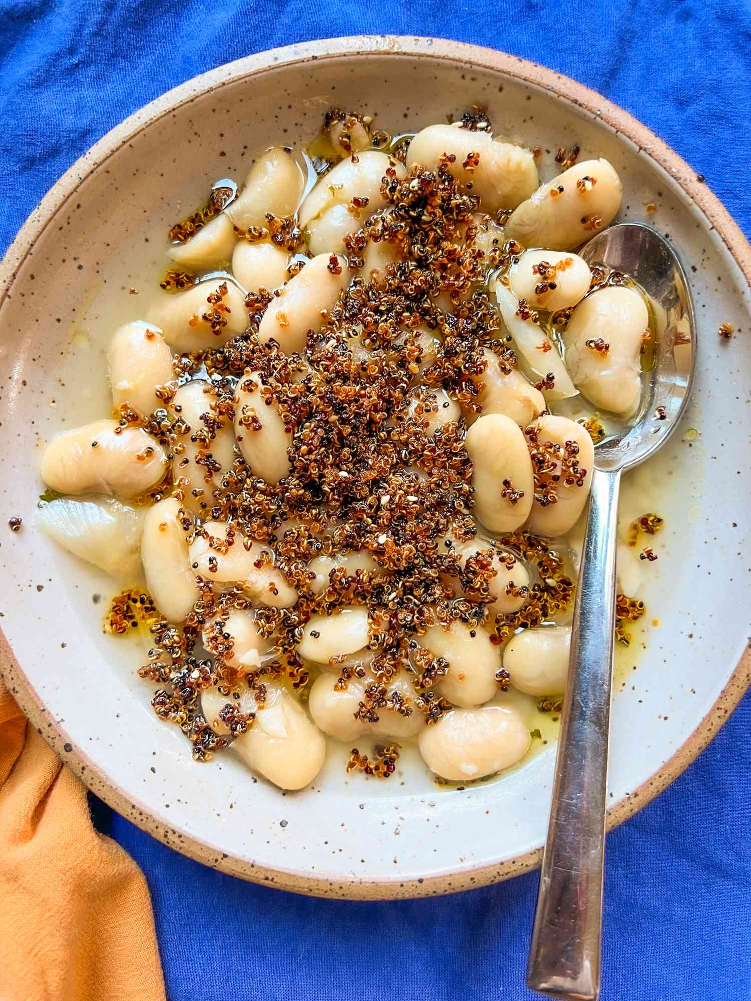 Crispy quinoa over a bowl of bean soup