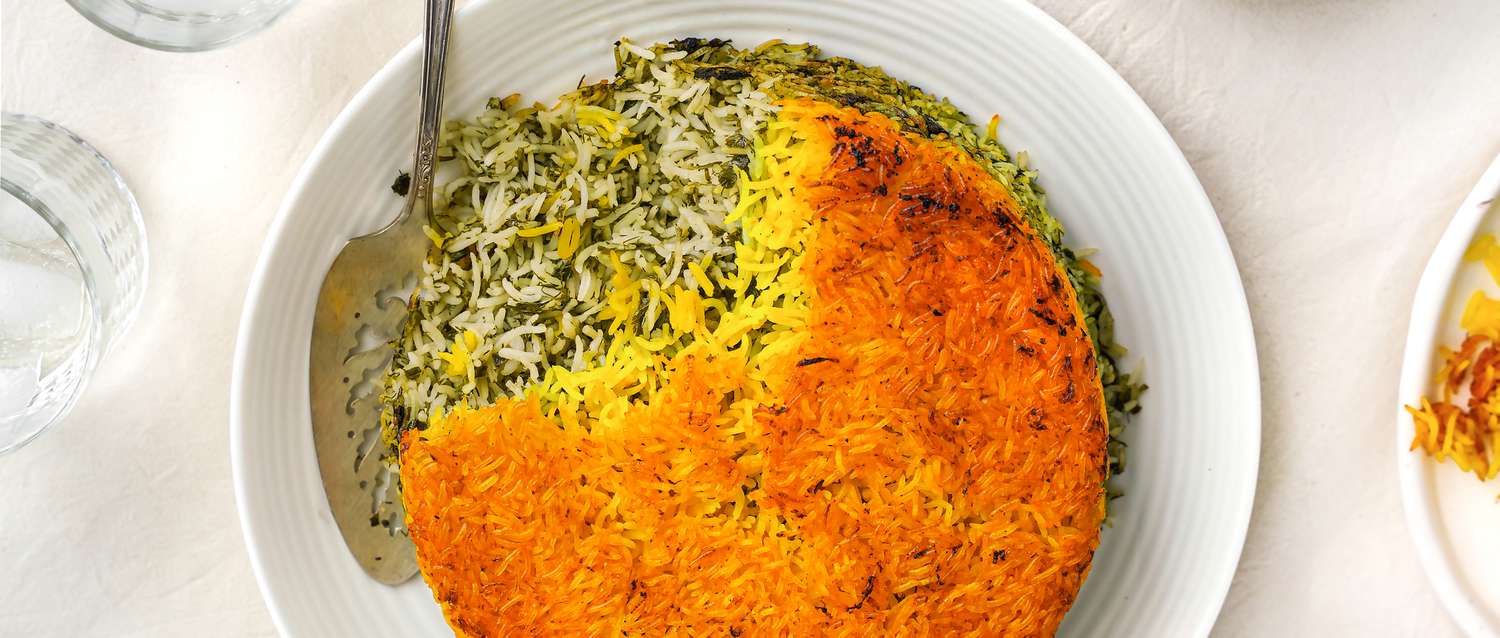 Sabzi polo on a platter with a serving utensil