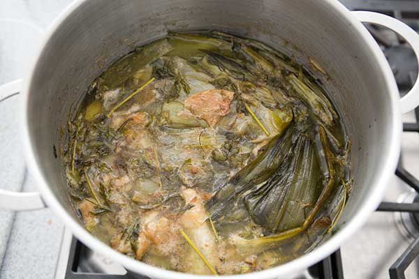 Chicken and vegetables in simmering water in a stock pot