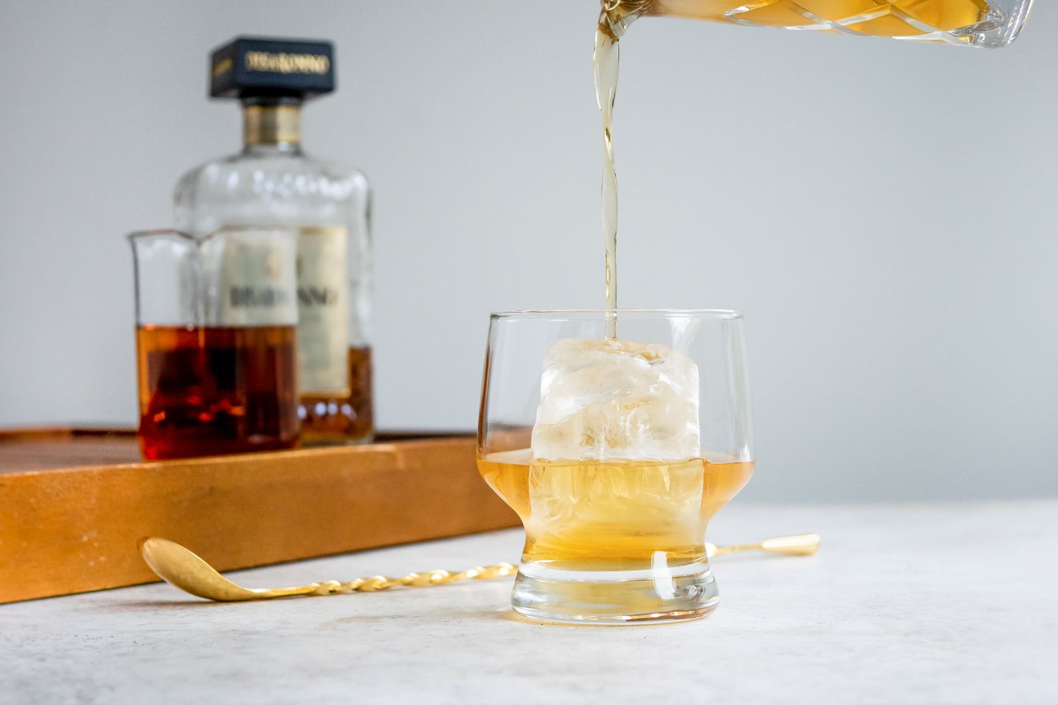 Godfather Cocktail Poured into a Glass with a Block of Ice