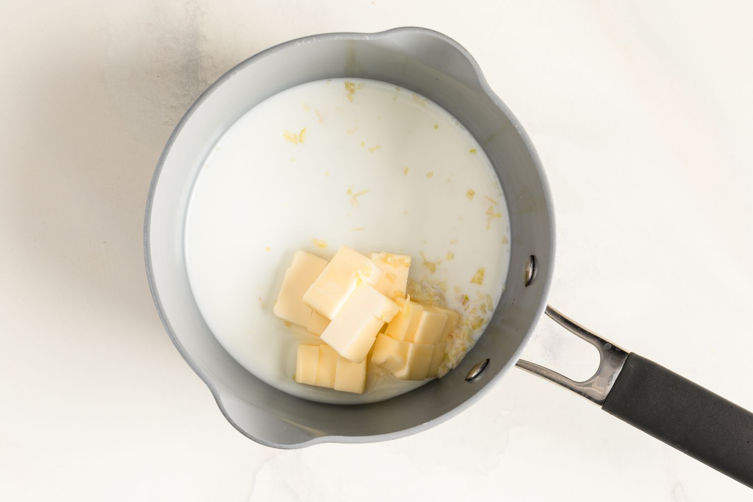 Milk, minced garlic, and cubed butter in a small saucepan