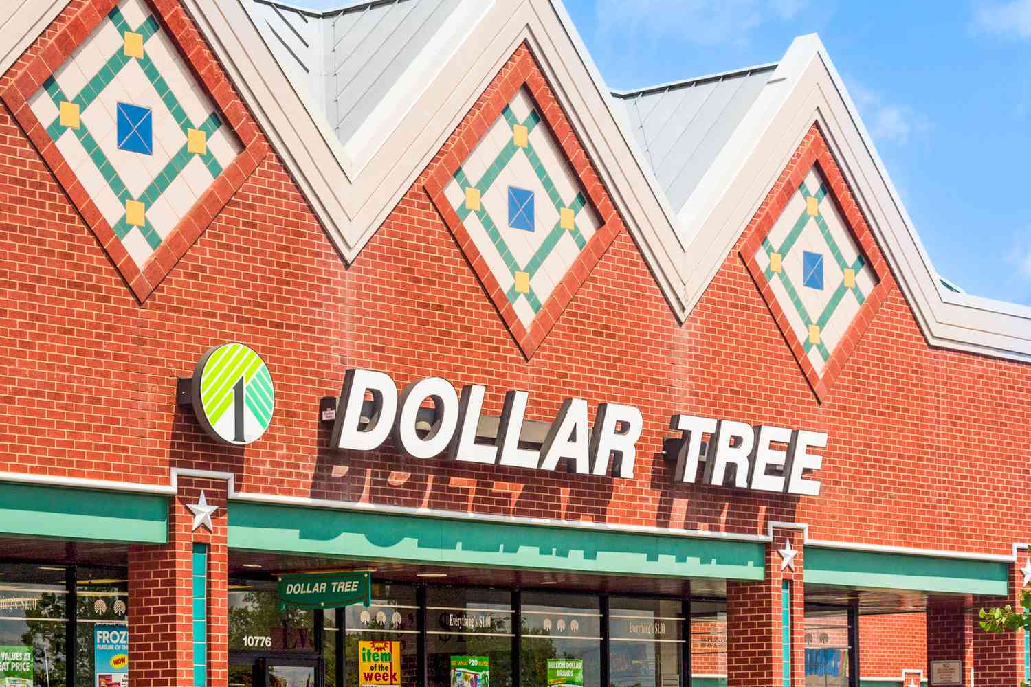 Exterior of a Dollar Tree store with a brick facade and decorative triangular roofing