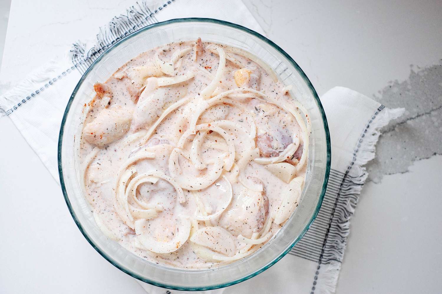 Chicken in buttermilk mixture to make fried chicken breast.