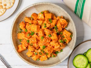 Overhead shot of a plate with gochujang chicken salad topped with chopped scallion