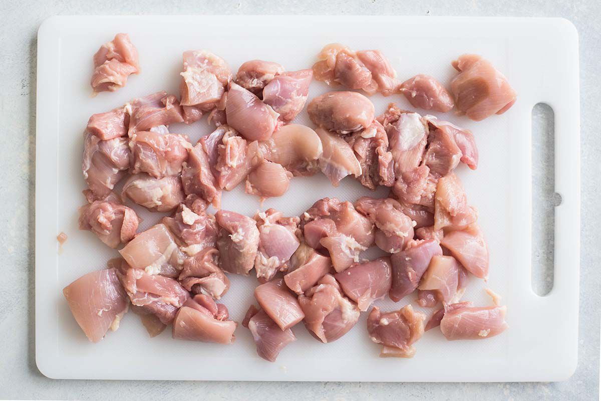 Best Chicken Tikka Masala Recipe raw chicken meat for chicken tikka masala on a cutting board