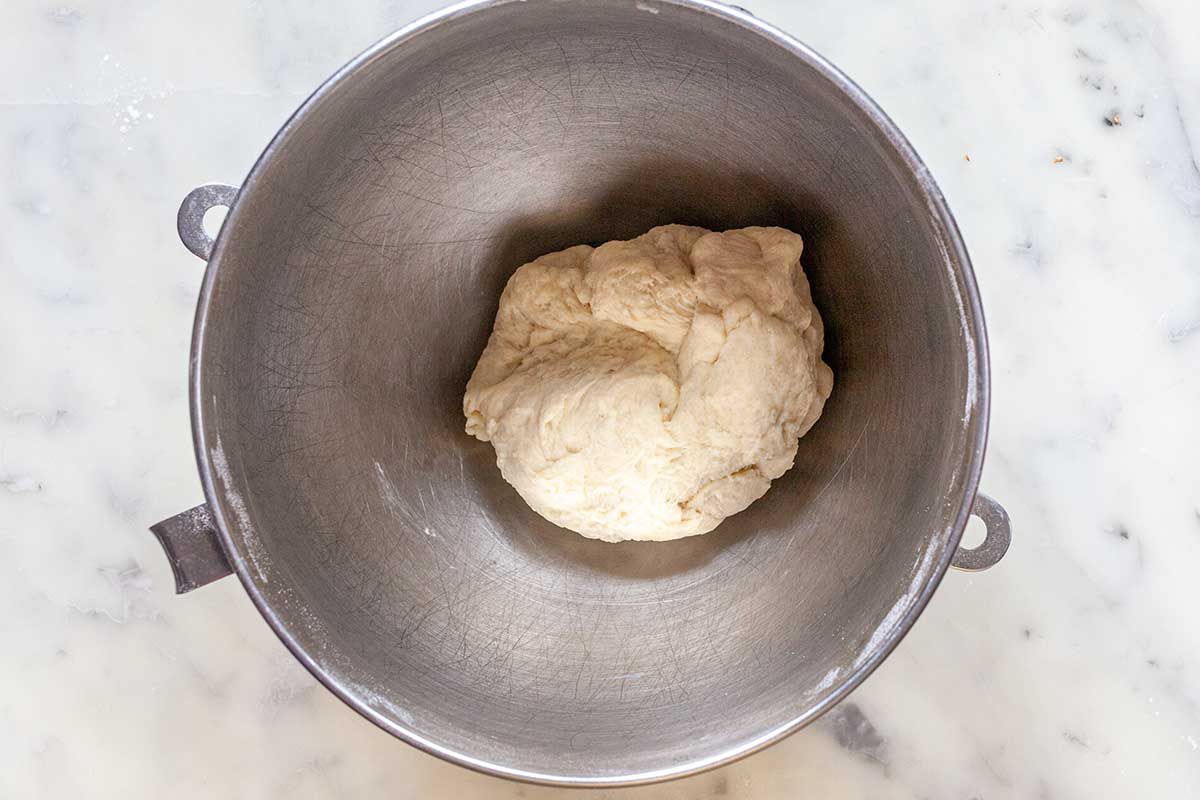 Dough for easy homemade flour tortillas is in a stand mixer bowl.