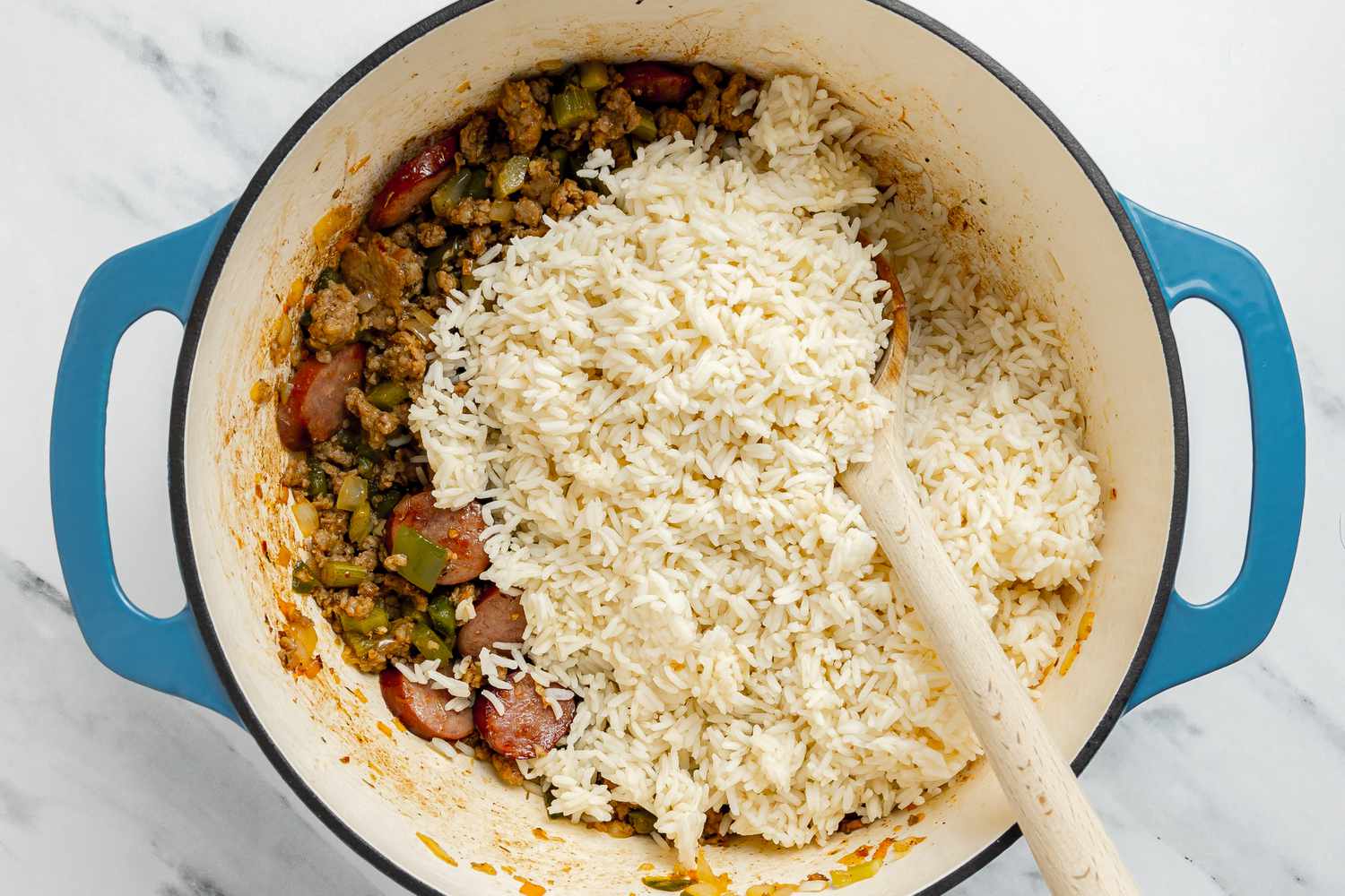 Rice Stirred Into the Ingredients in the Dutch Oven 