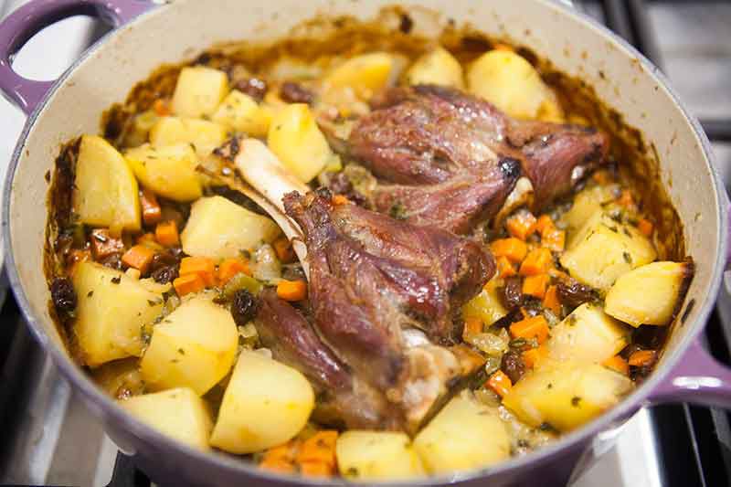 Lamb shank with potatoes baked in oven