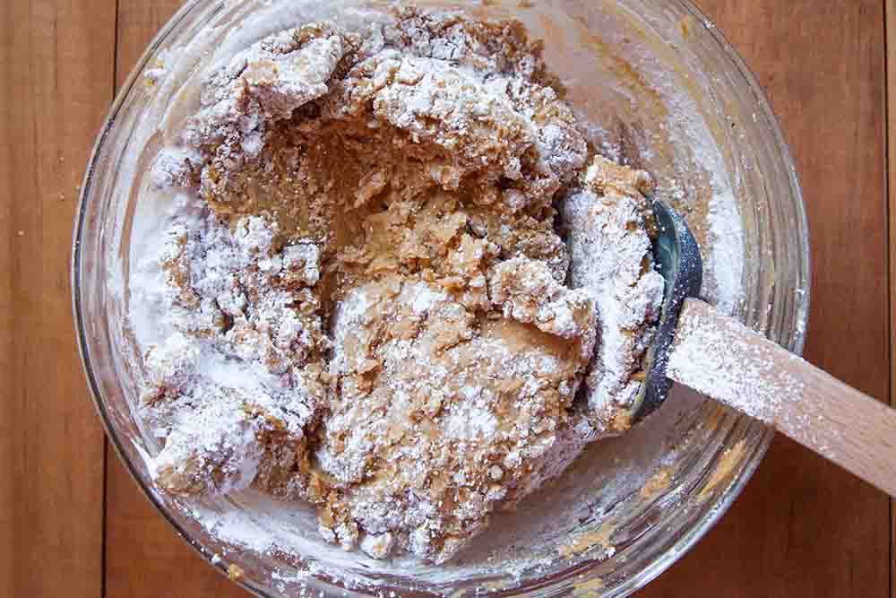 Powdered sugar being mixed into the filling for buckeye cookies.