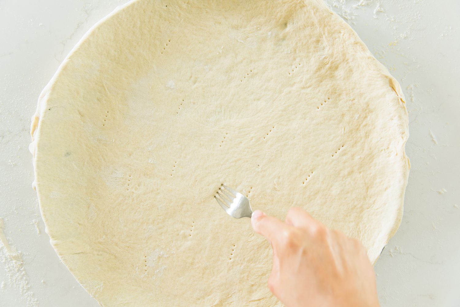 Fork Used to Poke Holes into Cheeseburger Pizza Crust 