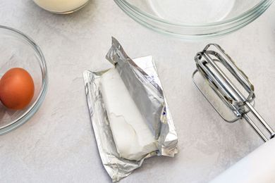 overhead view of countertop with opened block of cream cheese