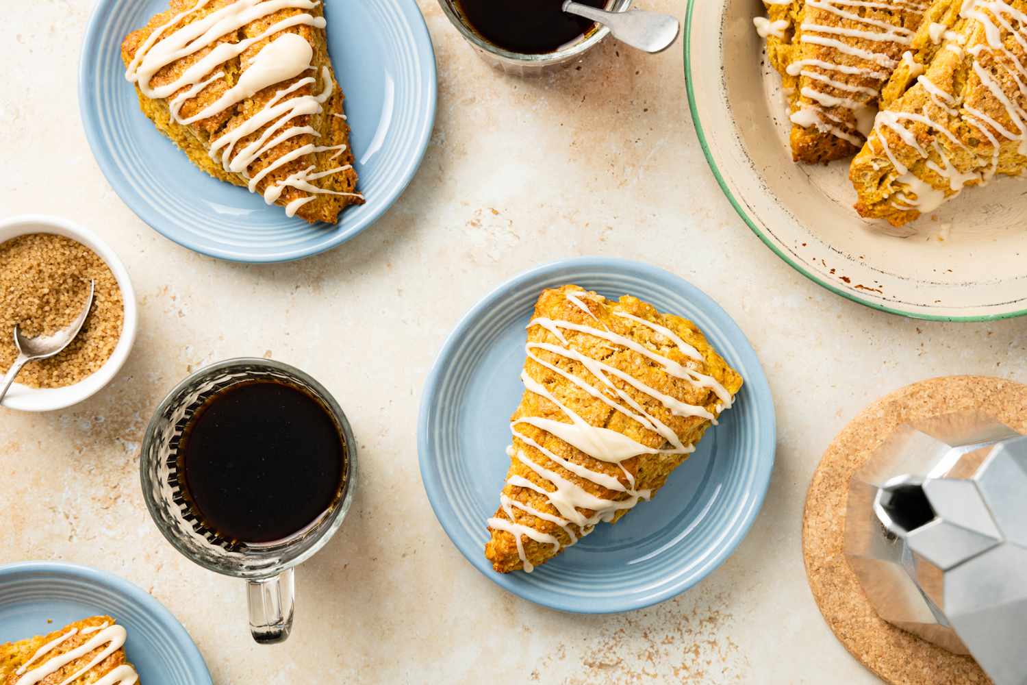 Pumpkin Scones on Plates Surrounded by Cups of Coffee