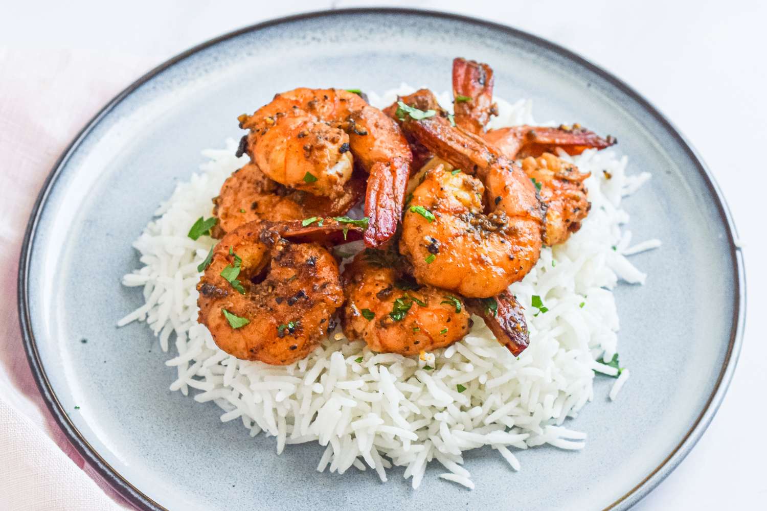 Shrimp seasoned with garlic and pepper on a bed of white rice