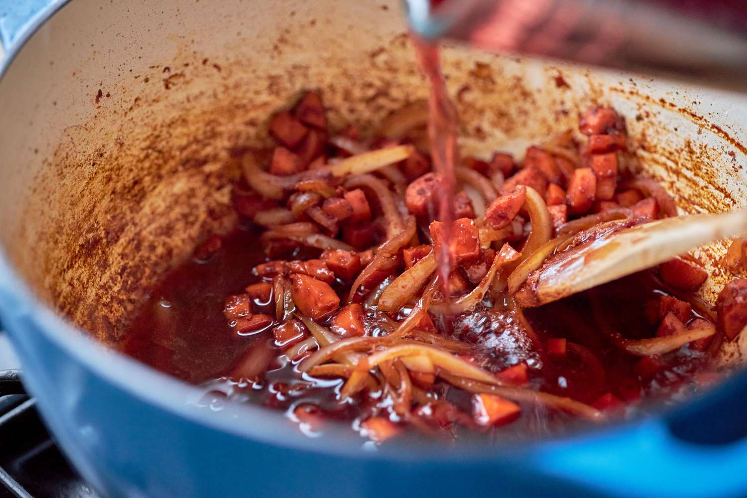 Red wine added to Dutch oven for holiday rouladen recipe