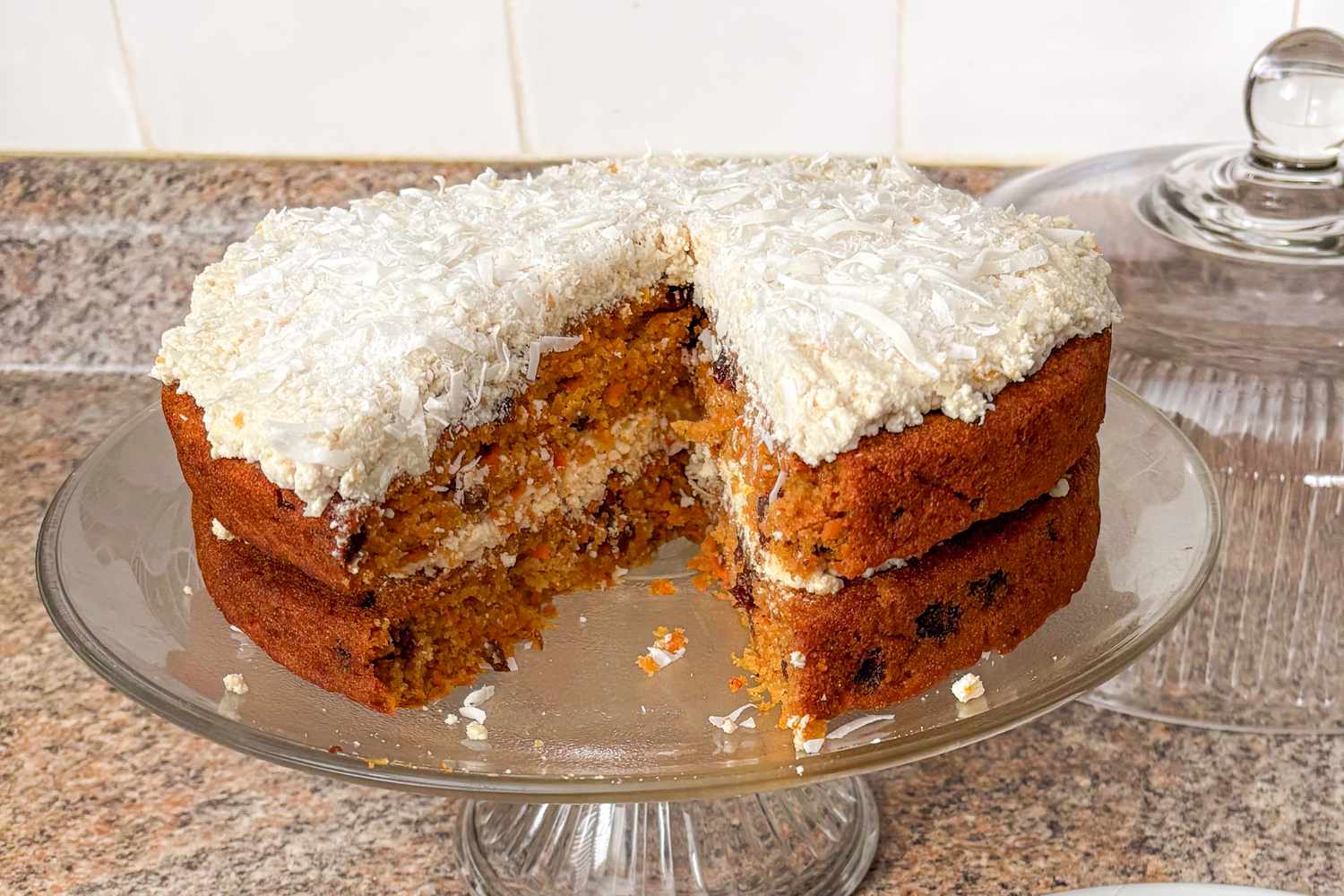 Julie Andrews' Carrot Cake on a glass cake stand, one slice removed