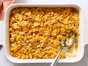 Pineapple Casserole in a casserole dish with a large serving spoon next to a scooped out section