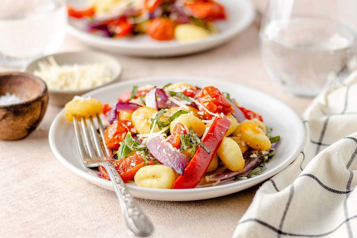 Sheet Pan Gnocchi with Zucchini, Tomatoes, and Bell Peppers on a Plate with a Piece on a Fork