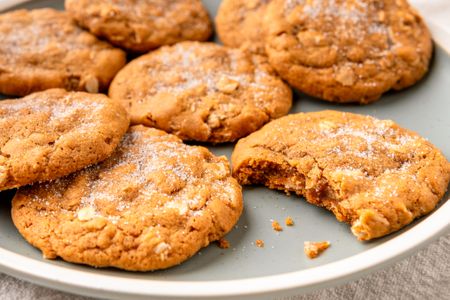 Plate of oatmeal molasses cookies one with a bite taken out