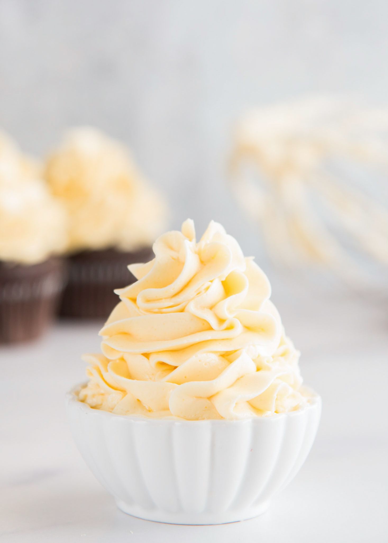 French meringue buttercream piled high in a small bowl.