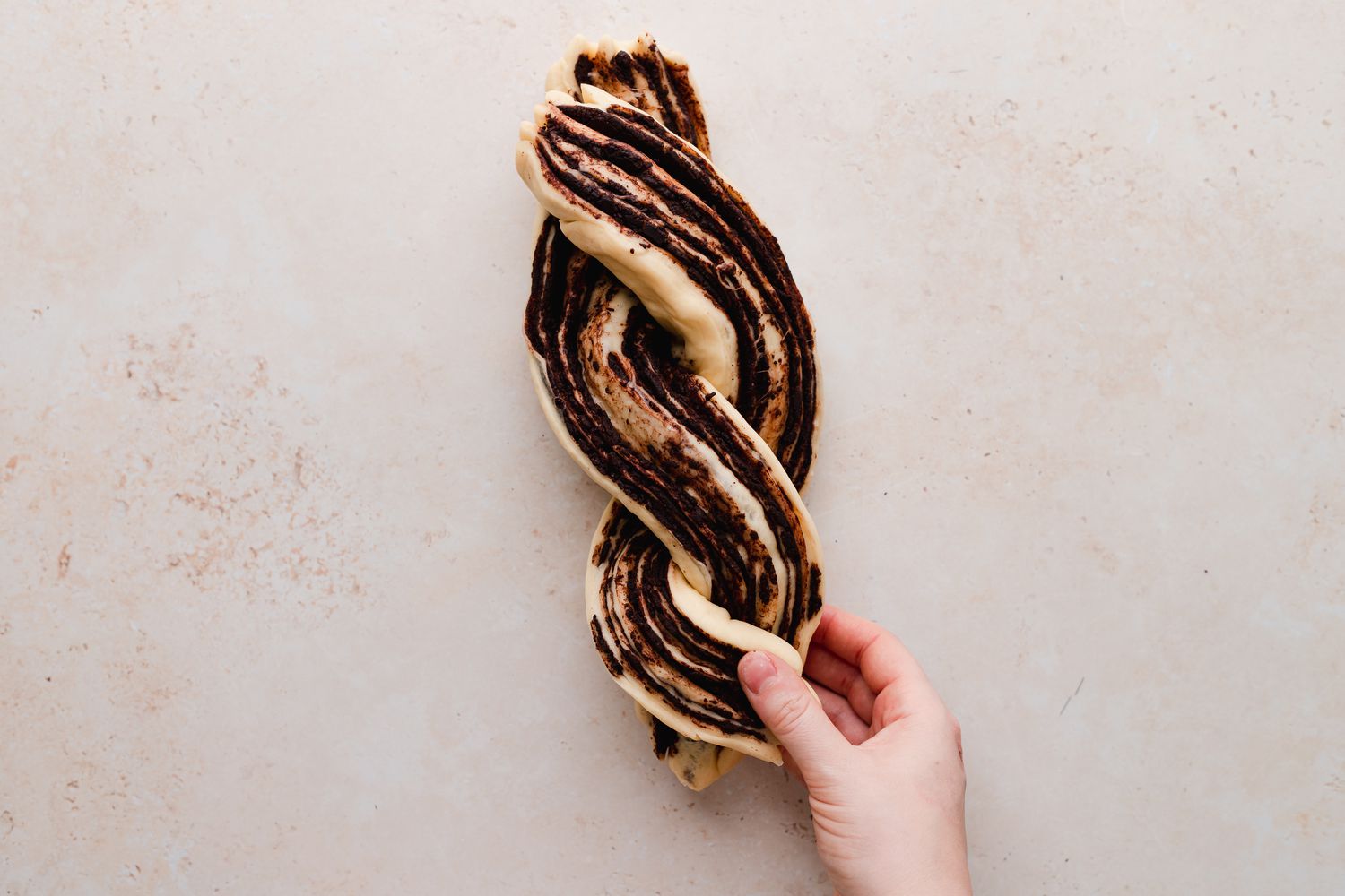 Braiding chocolate babka.