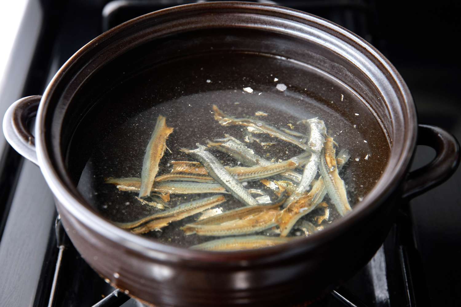 Large Anchovies Boiling in a Korean Clay Pot Filled With Water for Soybean Paste Stew Recipe