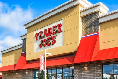 Front facade of a Trader Joes store with red awnings