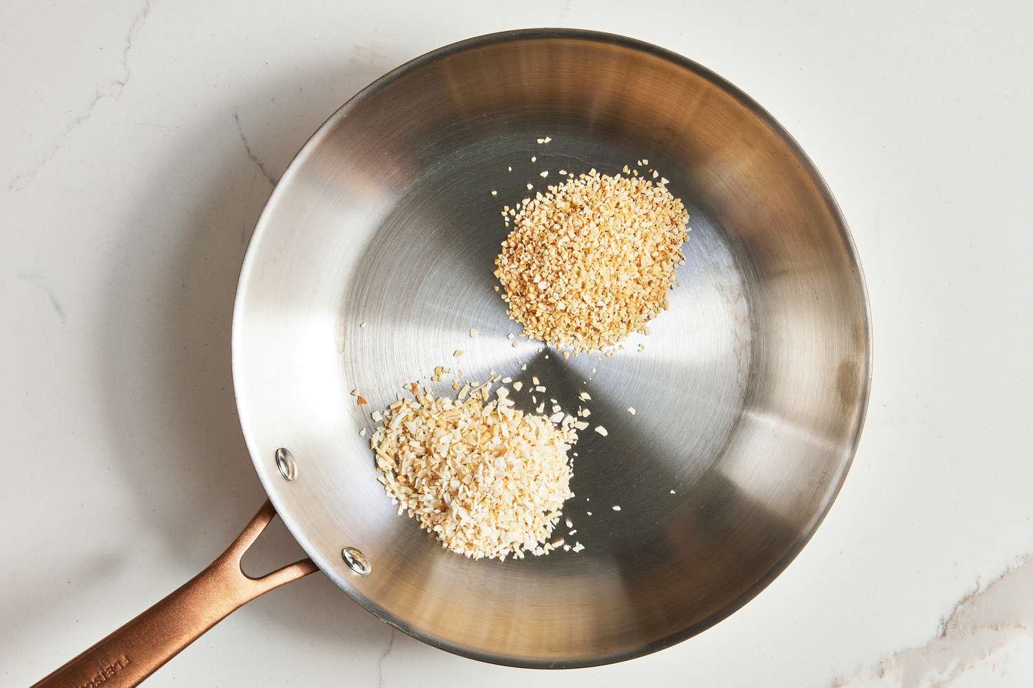 Garlic and Onion Flakes Toasted in a Stainless Steel Pan for Everything Bagel Seasoning Recipe