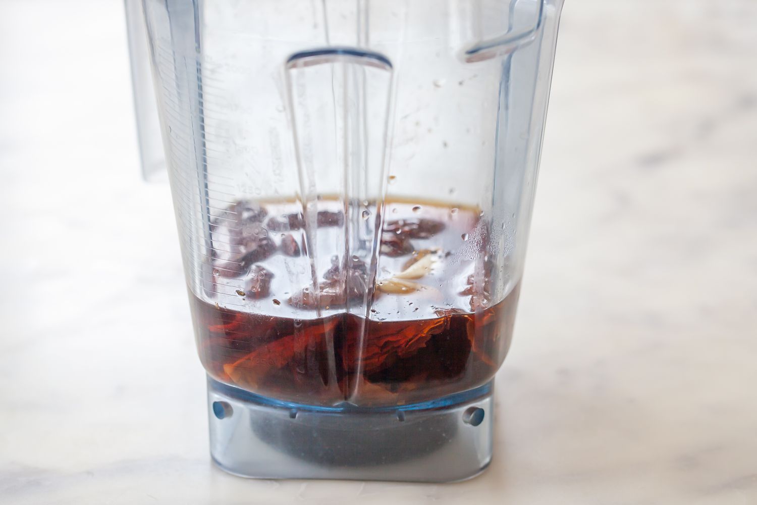 A blender with ingredients to make mexican hot sauce.