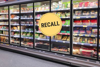 Grocery store refrigerated shelves, yellow recall sign overlay
