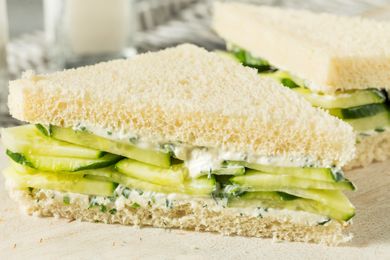 Cucumber sandwiches on a plate, featuring layers of cucumber and a white bread base