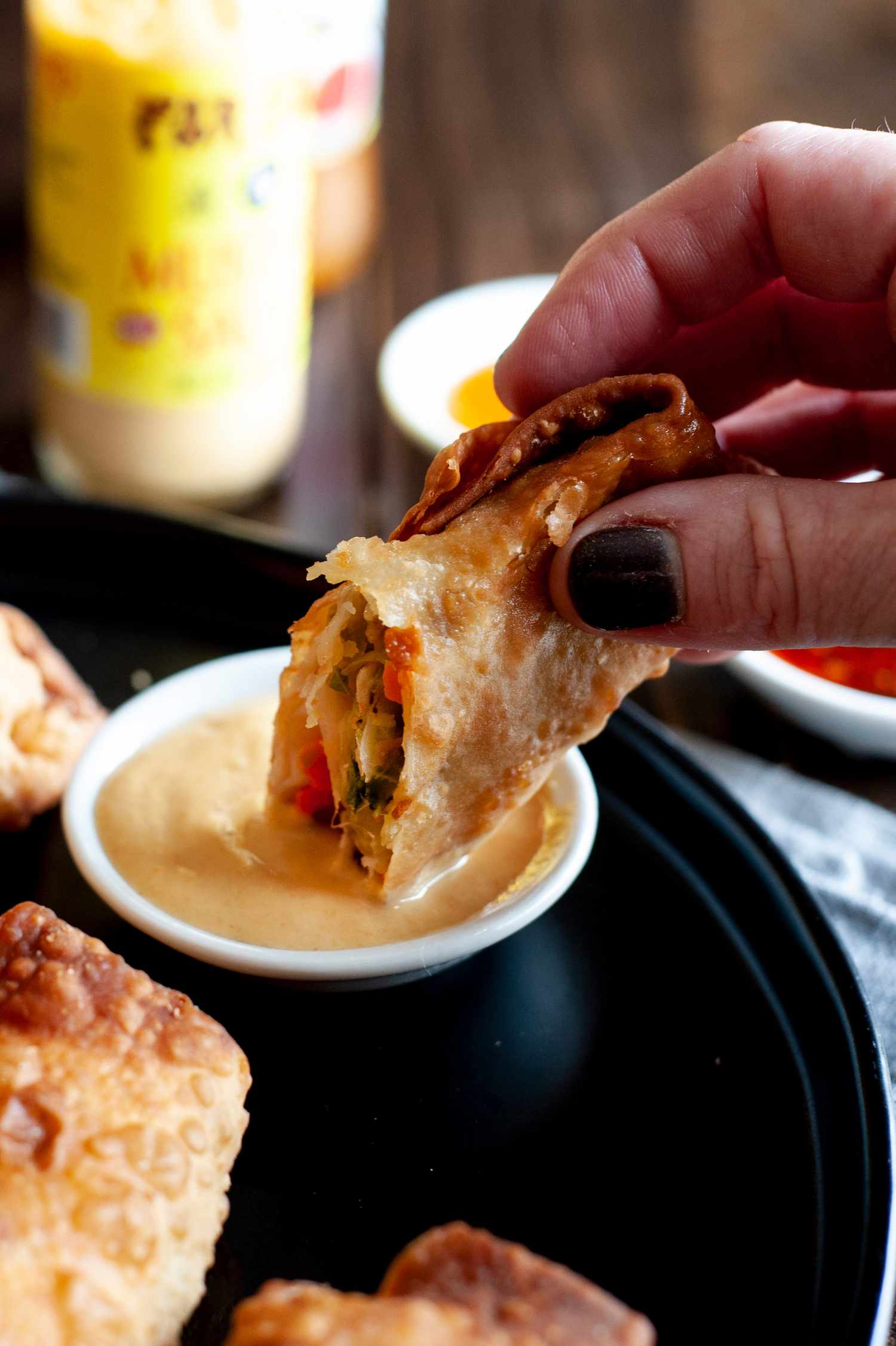 Dipping an easy fried egg roll into sauce.