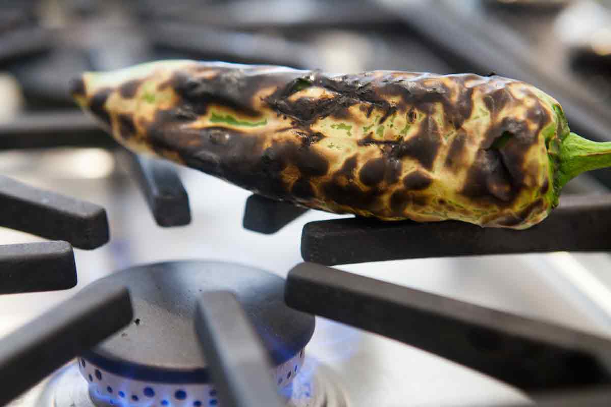 Easy enchilada recipe charred chile pepper on stove flame