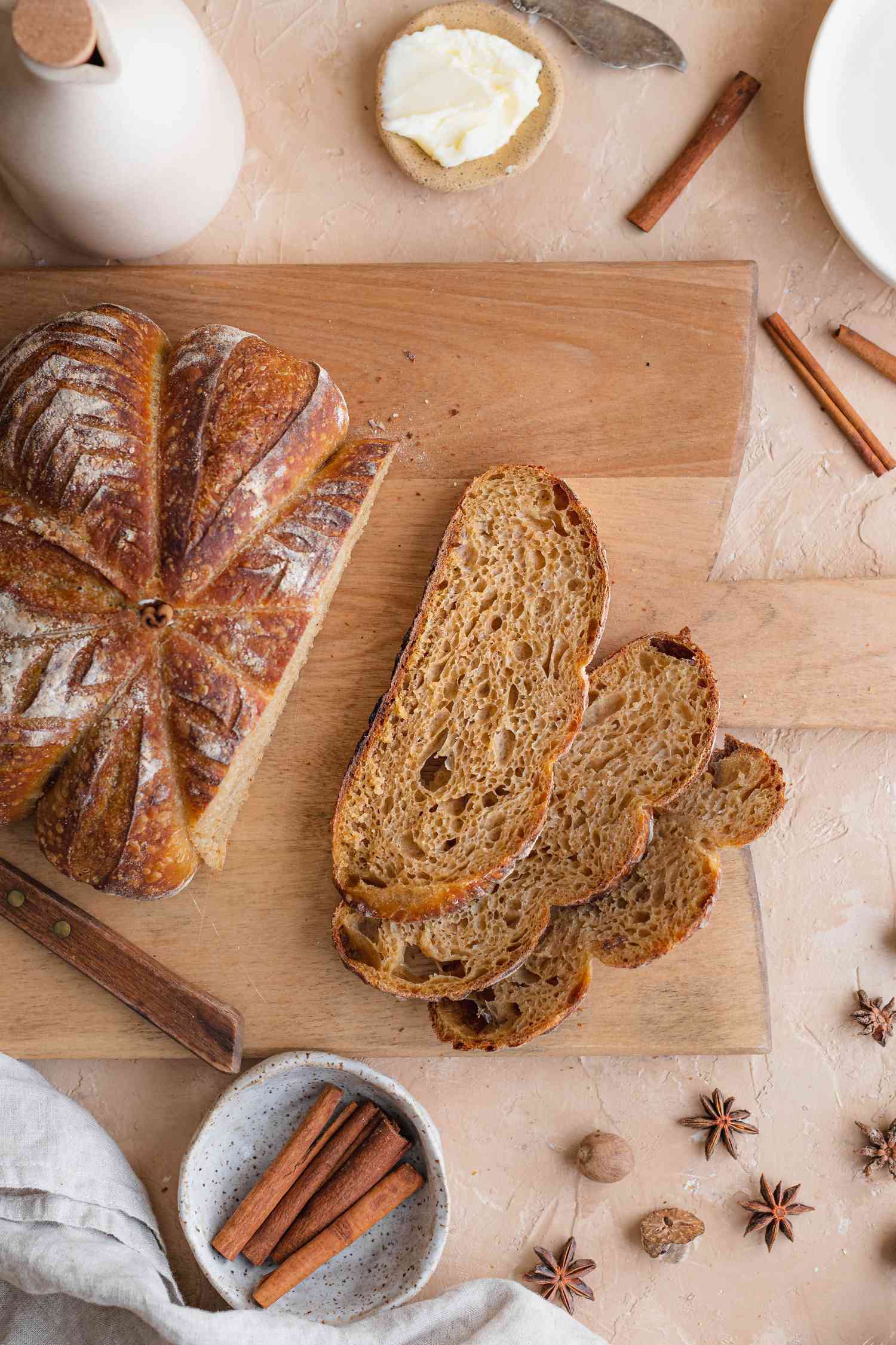 Pumpkin-shaped sourdough on a cutting board and cut into slices.