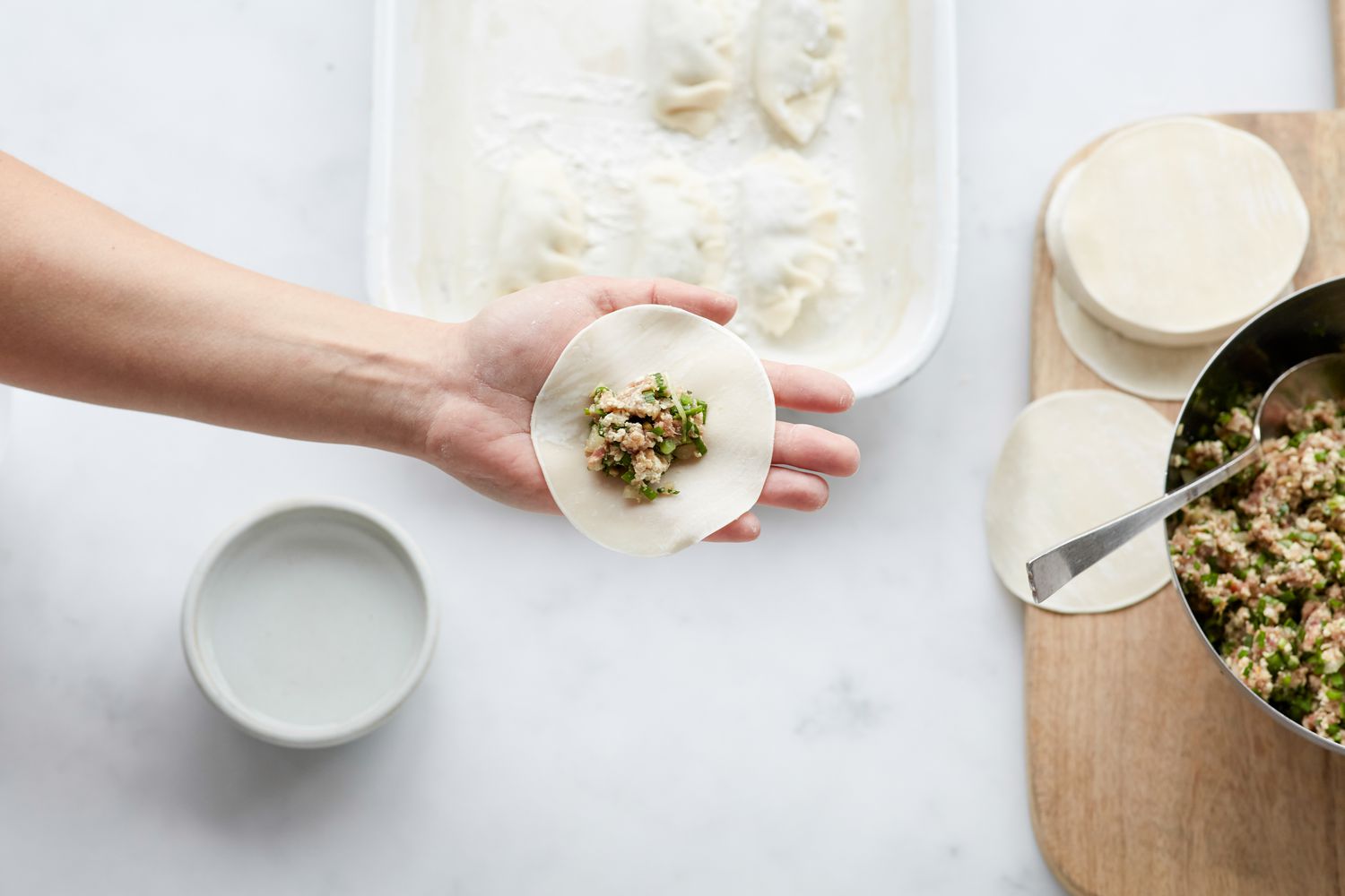 Filling Korean pork and chives dumplings 