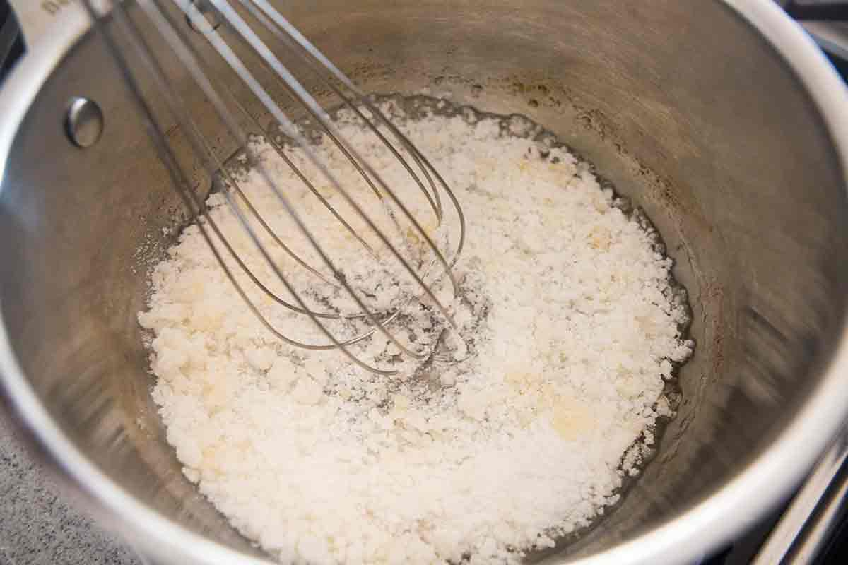 sugar in pan with whisk clumping and turning amber color