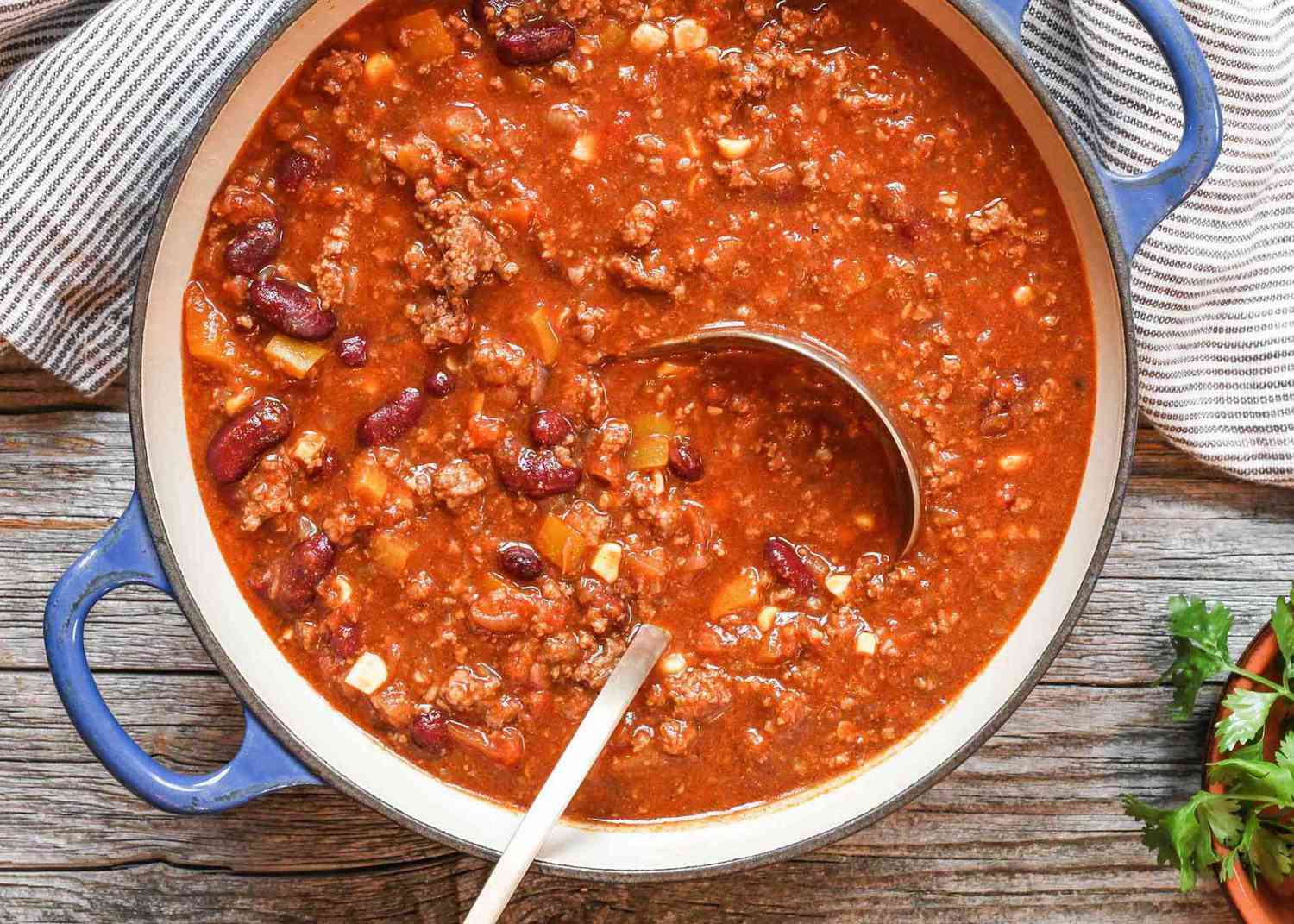 Beef chili in a blue Dutch oven.