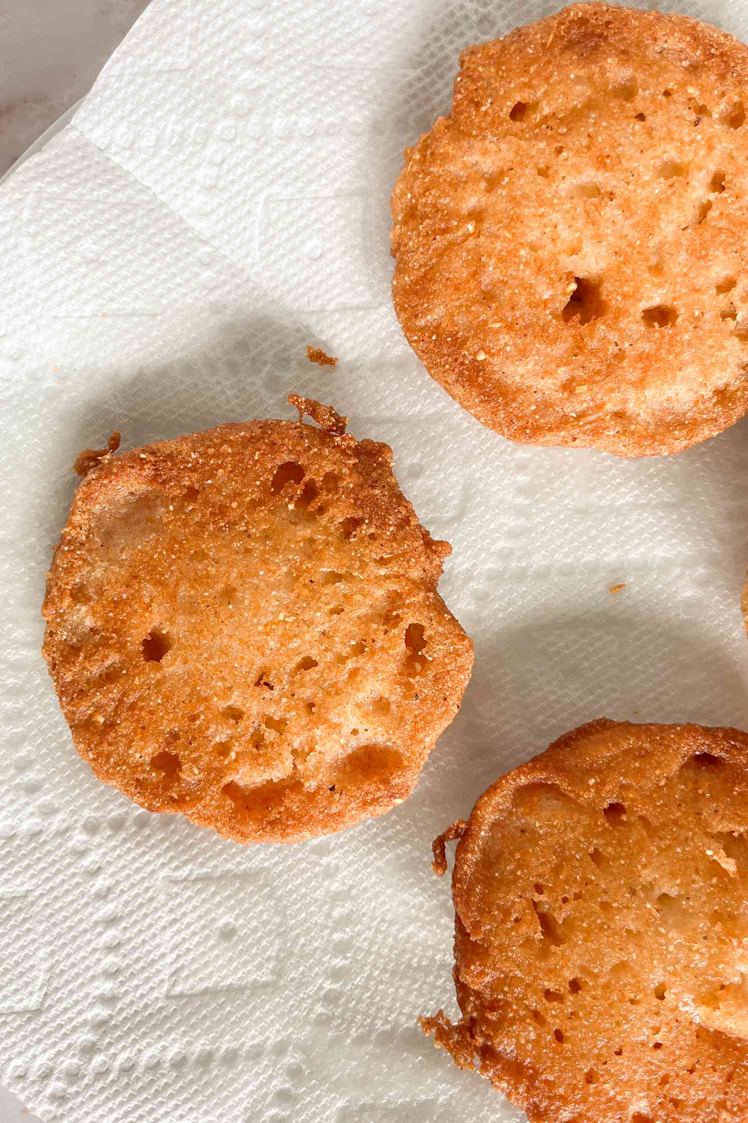 hot water cornbread resting on paper towel