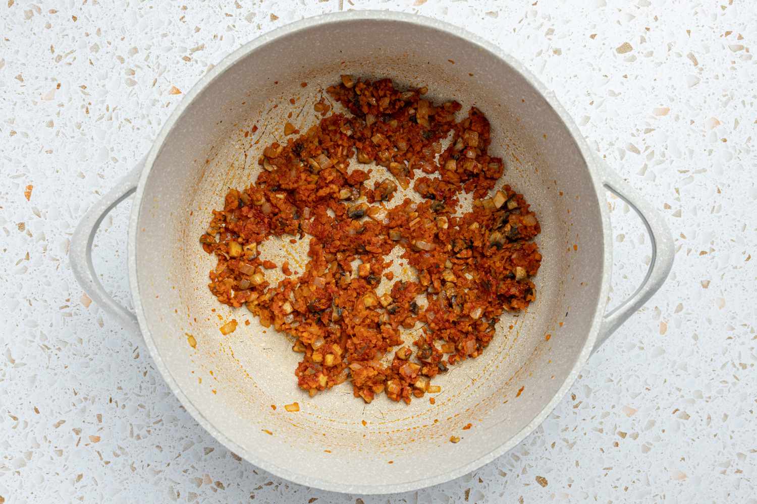 Onions, Mushrooms, Carrots, and Tomato Paste Cooked Together in a Pot for Spaghetti and Meatballs Recipe