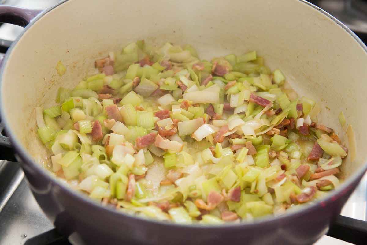 celery, leeks and bacon cooking in a pot