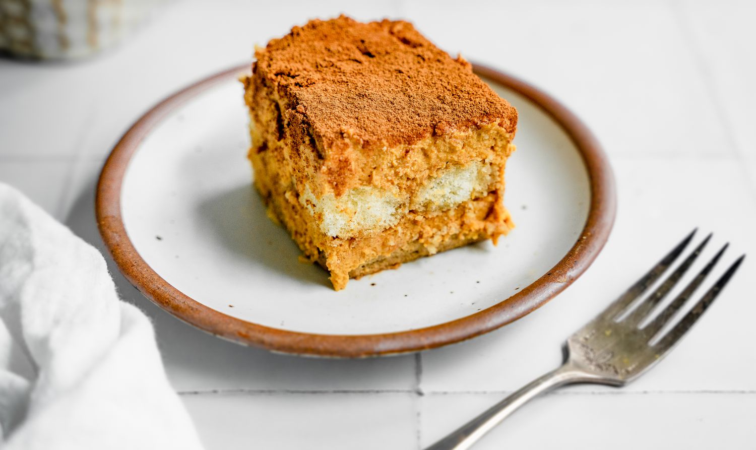 Slice of Pumpkin Tiramisu on a Plate Next to a Fork