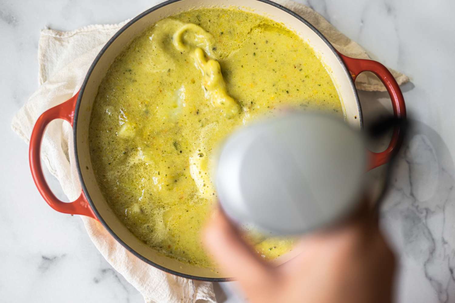 Using an immersion blender to blend soup