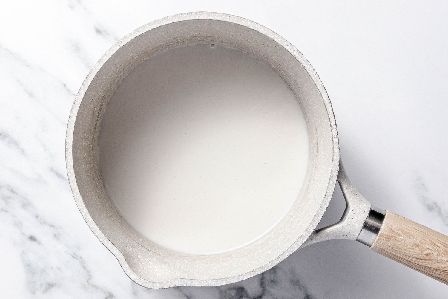 Coconut Sauce Ingredients Boiling Together in a Pot for Che Ba Mau Recipe